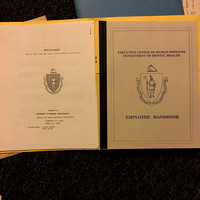 Employee Handbook and paperwork in folder